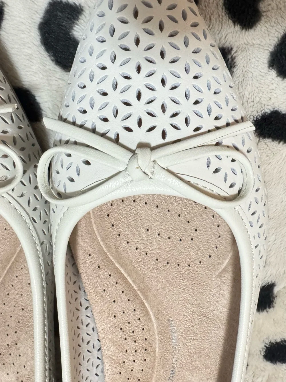 Comfortiva White Laser-Cut Bow Ballet Flats